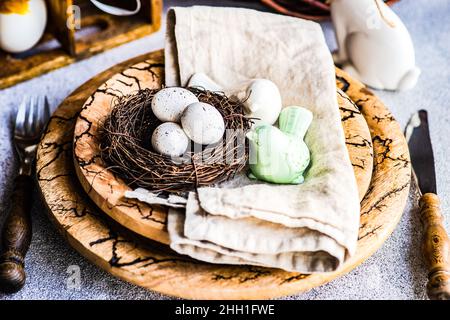 Easter dinner table settinf with colored eggs served on the table Stock Photo