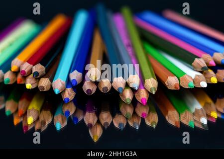 Colored pencils and reflection on black background Stock Photo