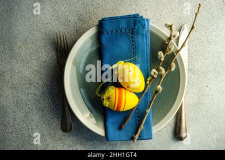Easter dinner table settinf with colored eggs served on the table Stock Photo