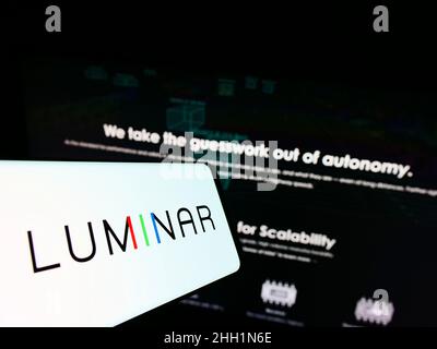 Cellphone with logo of American lidar company Luminar Technologies Inc. on screen in front of website. Focus on center-right of phone display. Stock Photo