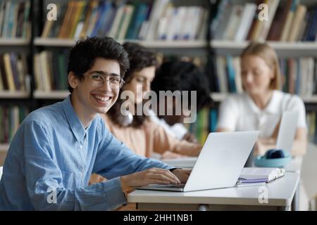 Happy high school student in glasses working on project Stock Photo