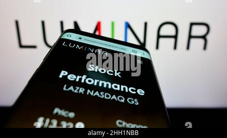 Mobile phone with webpage of US lidar company Luminar Technologies Inc. on screen in front of business logo. Focus on top-left of phone display. Stock Photo