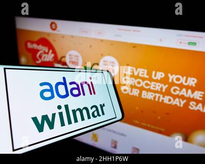 Cellphone with logo of Indian company Adani Green Energy Limited on screen  in front of business website. Focus on center-left of phone display Stock  Photo - Alamy