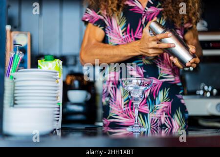 Handsome curly hair bartender preparing cocktail at the resort bar Stock Photo