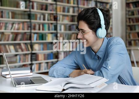 Happy engaged high school, college student in bright wireless headphones Stock Photo