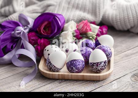 Close-up of Easter eggs decorated with purple sparkles. Stock Photo