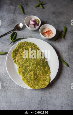 Green peas stuffed Indian flat bread or matar ka paratha served. Close up. Stock Photo