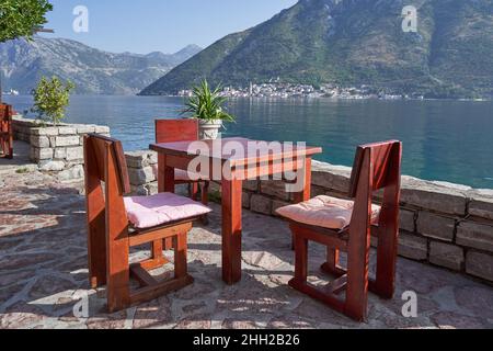 Wooden table in a street cafe overlooking the sea Stock Photo