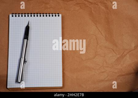 White Spiral notebook and Lamy fountain pen with copy space Stock Photo