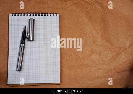 White Spiral notebook and Lamy fountain pen with copy space Stock Photo