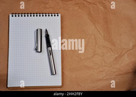 White Spiral notebook and Lamy fountain pen with copy space Stock Photo