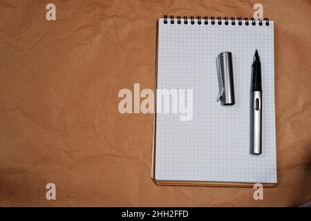 White Spiral notebook and Lamy fountain pen with copy space Stock Photo