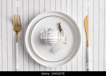 Stylish festive Easter table setting. White plate with decoration Stock Photo