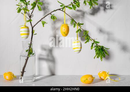Easter tree with colorful Easter eggs against gray wall Stock Photo