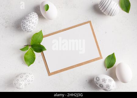 flat lay composition with blank paper card and easter eggs Stock Photo