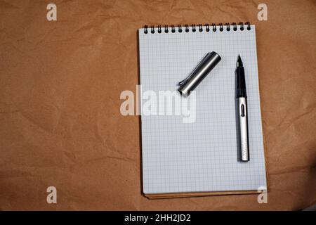 White Spiral notebook and Lamy fountain pen with copy space Stock Photo