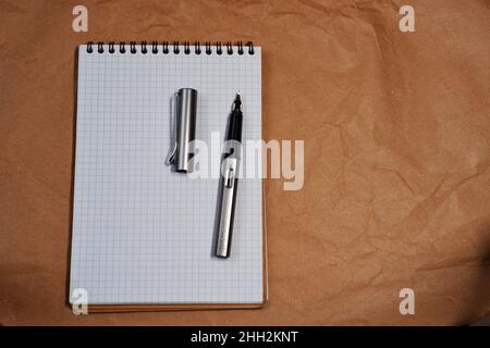 White Spiral notebook and Lamy fountain pen with copy space Stock Photo