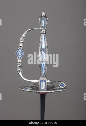 Smallsword Hilt ca. 1790 Matthew Boulton British This hilt combines two of the most popular elements of English jewelry during the last quarter of the eighteenth century: highly polished cut-steel beads and blue-and-white cameos of Wedgwood jasperware. The industrialist Matthew Boulton (1728–1809) of Birmingham, who specialized in cut-steel articles, is known to have collaborated with Josiah Wedgwood (1730–1795) in combining jasperware cameos and steel settings to make buttons, watch fobs, and chatelaines. It is likely that this hilt originated in Boulton's factory.. Smallsword Hilt. British, Stock Photo