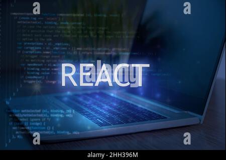 React inscription against laptop and code background. Technology concept. Learn react programming language, web development. Stock Photo