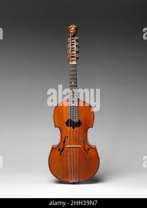 Violaline 1901 Georges Contal The violaline is a four double-course mandolin with a violin or viola d’amore shaped body. The arched top and back of the violin family of instruments is a very sturdy instrument design and helps to project the sound of the mandolin. This design was created by Georges Contal around 1900 in Paris. Similarly, Orville Gibson, working in the 1890s in Kalamazoo, Michigan, based the design of his mandolins and guitars on violin construction techniques. This example has the form of a viola d’amore, with a carved figural head, and without the pointed corners of a violin b Stock Photo