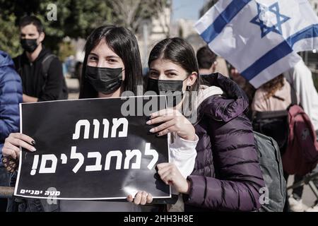 Jerusalem, Israel. 23rd Jan, 2022. Young women hold a Hebrew sign stating ‘Death to Terrorisrs' as a right wing demonstration takes place at the entrance to the Leyada High School hosting bereaved Israeli and Palestinian families, who have lost loved ones to the conflict, to encourage dialogue. MK Ben Gvir and supporters protest the school hosting what they call ‘families of Palestinian terrorists'. Credit: Nir Alon/Alamy Live News Stock Photo