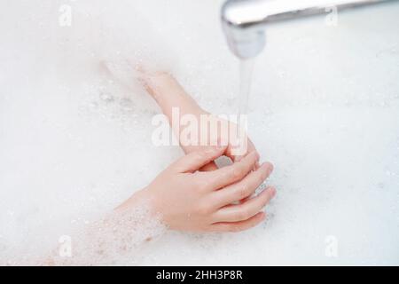 Child washing hand in bathroom. Medicine, hygiene concept. Stock Photo