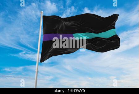 Thin Purple-Teal Line flag waving at cloudy sky background on sunset, panoramic view. Suicide awareness and prevention flag. copy space for wide banne Stock Photo