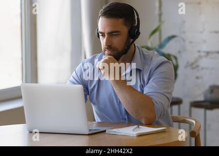 Millennial distant worker in headphones working from home Stock Photo