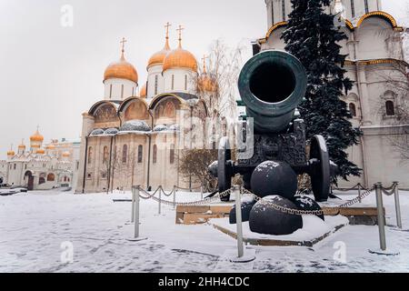 Inside the Kremlin's wall - Tsar pushka with Ivan the Great Bell Tower, Ivan the Great Bell and the Dormition Cathedral background in Cathedral Square Stock Photo