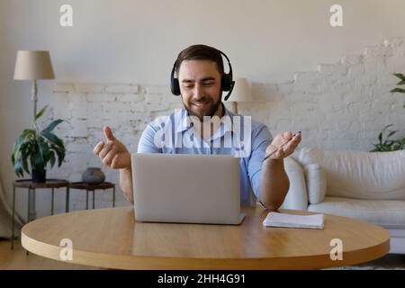 Happy adult male student studying on Internet from home Stock Photo