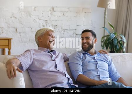 Happy joyful older father and grownup son joking and laughing Stock Photo