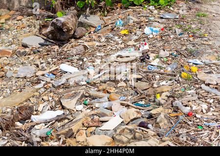 KOTA KINABALU, SABAH, MALAYSIA - JANUARY 06, 2022: Garbage and plastic bottles on a beach left in Tanjung Aru Beach Stock Photo