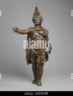 Bronze statuette of a boy in Eastern dress mid-late 1st century B.C. Greek, Ptolemaic or Roman Parallels for this boy's unusual and unclassical costume, particularly his trousers and ornate pyramidal hat, can be found in works from the eastern borders of the Hellenistic world in the kingdoms of Commagene and Armenia, north of Mesopotamia, beginning in the middle of the first century B.C. This statuette was found in Egypt together with an identical figure that is now in the collection of the Walters Art Gallery, Baltimore. The subject's identity has been much debated and remains a mystery. He m Stock Photo