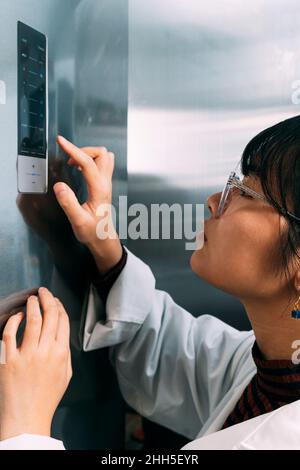 Young scientist using control panel Stock Photo