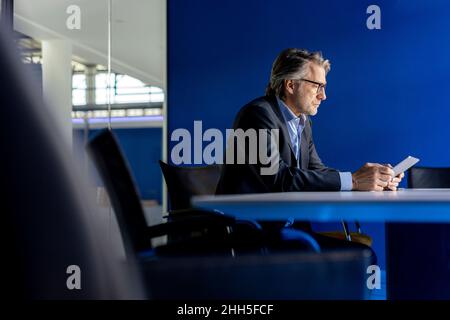 Businessman using tablet PC at workplace Stock Photo