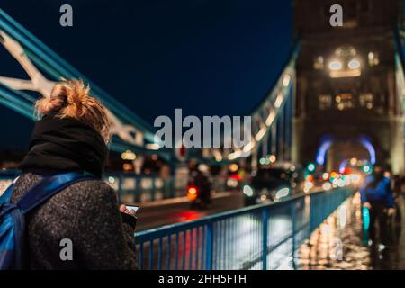 Woman using smart phone at Tower Bridge, London, England, UK Stock Photo