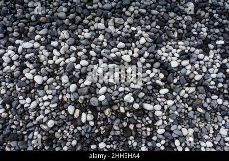 Gray and white pebbles heap at beach Stock Photo