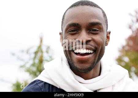 Young man laughing in park Stock Photo