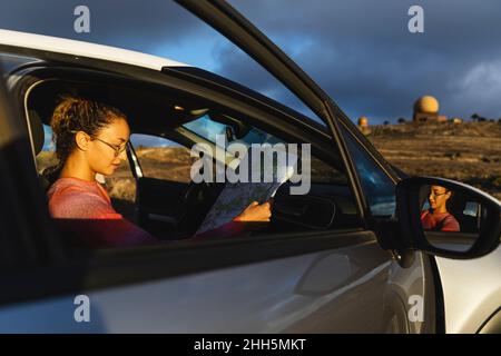 Young woman holding map in car Stock Photo