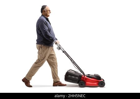 Full length profile shot of a mature man using a lawnmower isolated on white background Stock Photo