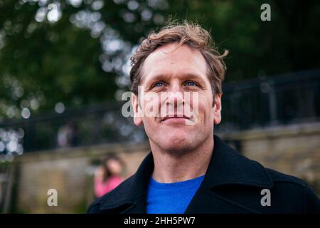 Smiling man wearing jacket looking away Stock Photo
