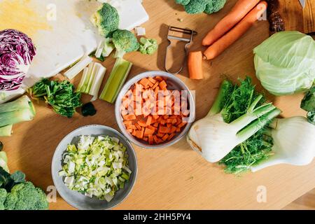 Chopped and sliced fresh vegetables on table at home Stock Photo