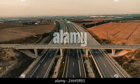 Empty highway below bridge near field in Lleida, Spain Stock Photo