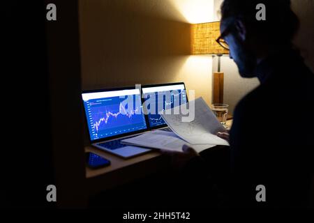 Working man reviewing documents late night in home office Stock Photo
