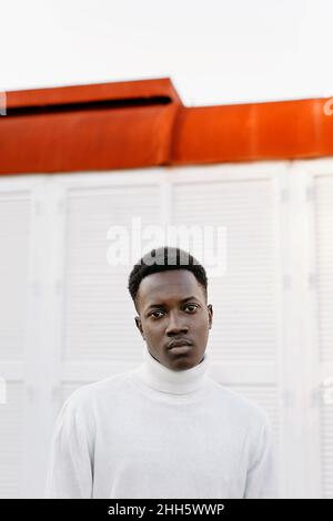 Confident young man wearing white turtleneck Stock Photo