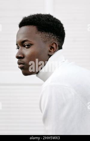 Confident young man wearing white turtleneck Stock Photo