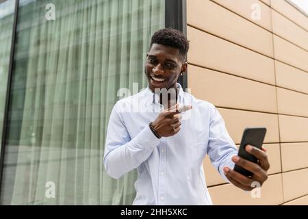 Smiling man on video call through smart phone Stock Photo
