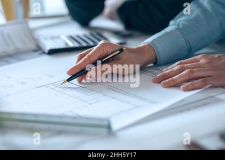 Businesswoman holding pen over diagram on paper Stock Photo
