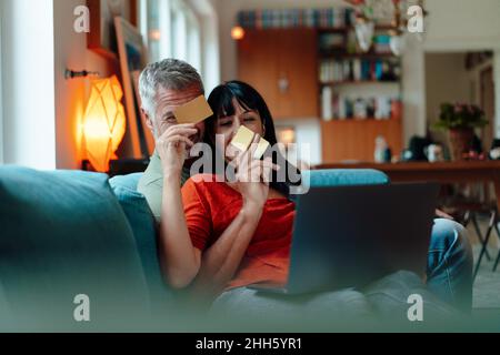 Mature couple doing online shopping at home Stock Photo