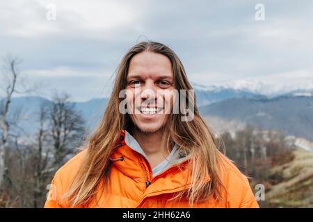 Cheerful man with long blond hair Stock Photo